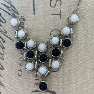 Silver necklace with a beautiful white and black drop down
